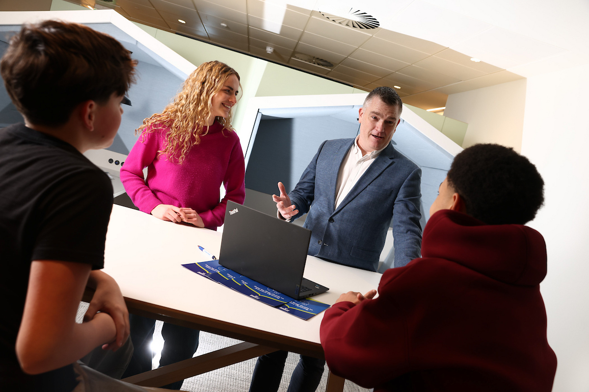 Youth of different ages talking with the Bank of Ireland Head of Youth, around a table