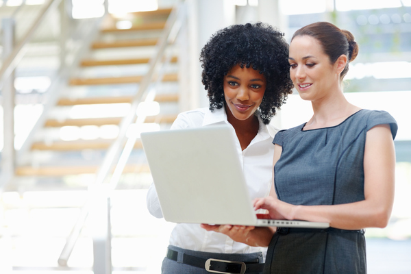 Two business women using a laptop