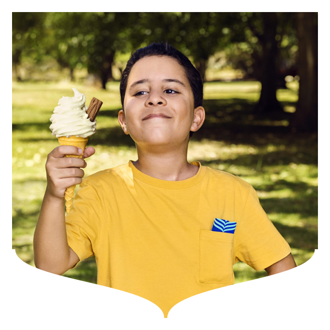 A young boy holding an ice cream in his hand, with a Bank of Ireland card in his pocket.